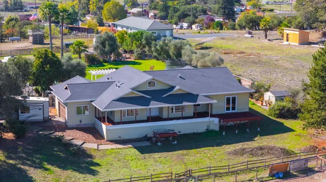 a aerial view of a house with swimming pool garden and patio