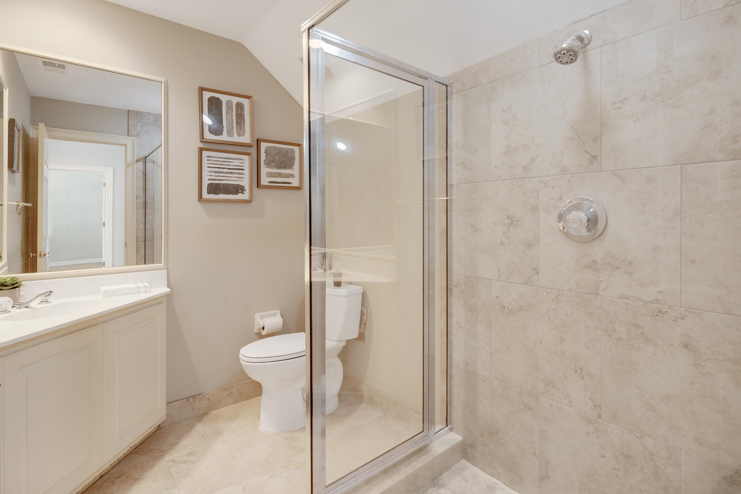 3345 Gallery Drive Memphis, TN 38125 - Photo 24 of 25 a bathroom with a granite countertop toilet a sink and shower