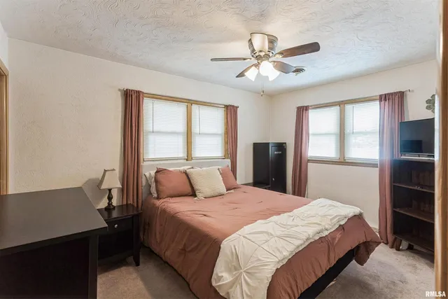 a bedroom with a large bed and a window