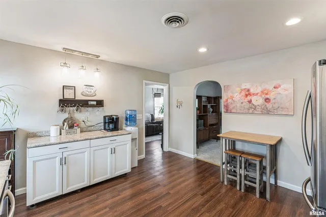 a view of a kitchen with sink and wooden floor