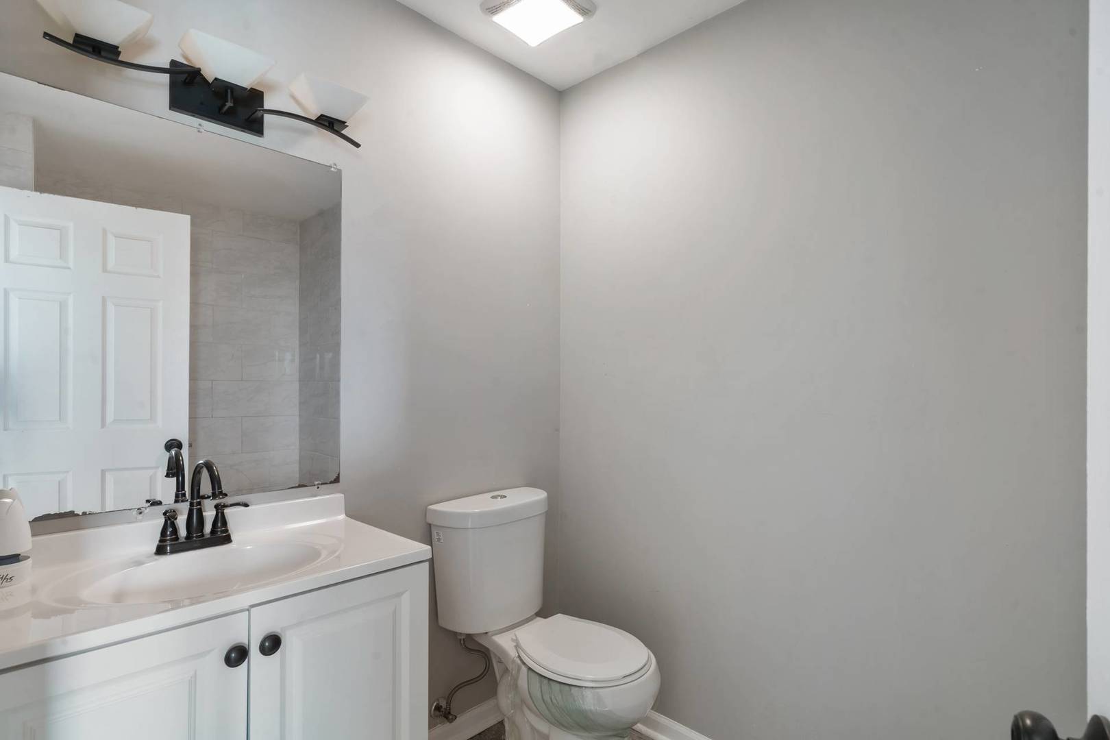 50 Willow Road Matteson, IL 60443 - Photo 12 of 21 a bathroom with a sink a toilet and mirror