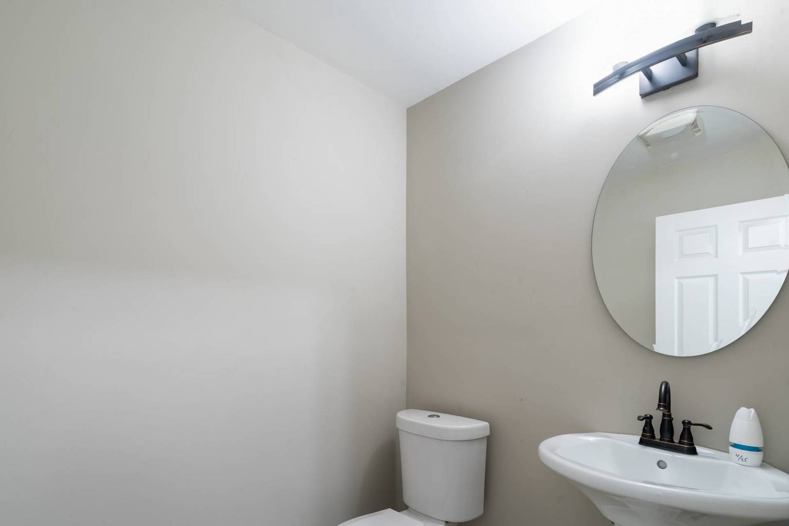50 Willow Road Matteson, IL 60443 - Photo 18 of 21 a bathroom with a toilet a sink and mirror