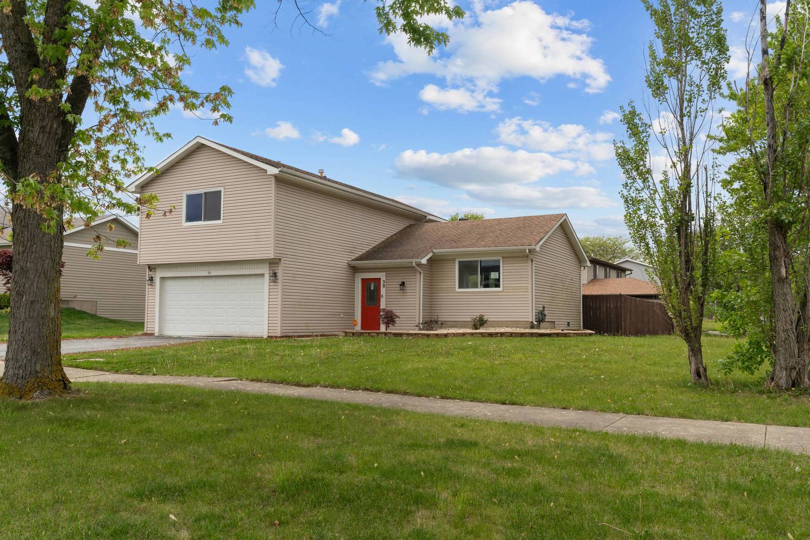 50 Willow Road Matteson, IL 60443 - Photo 20 of 21 a house that is sitting in the grass with large trees