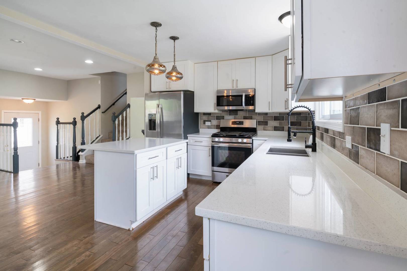 50 Willow Road Matteson, IL 60443 - Photo 4 of 21 a kitchen with stainless steel appliances kitchen island granite countertop a sink a stove top oven a counter space and cabinets