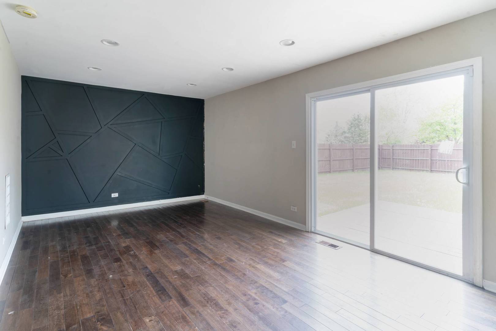50 Willow Road Matteson, IL 60443 - Photo 5 of 21 a view of an empty room with wooden floor and a window