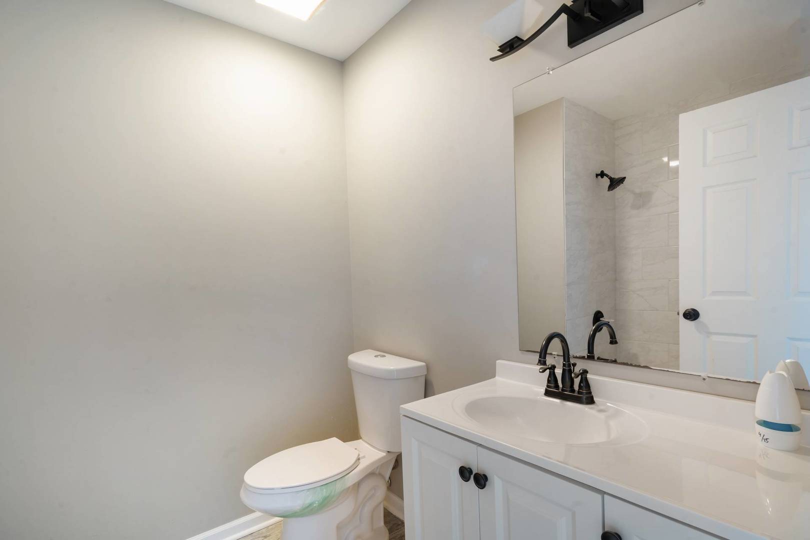 50 Willow Road Matteson, IL 60443 - Photo 8 of 21 a bathroom with a toilet a sink and mirror