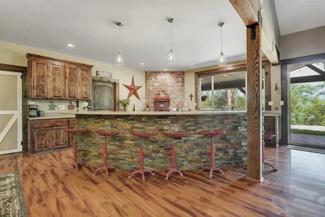 a bathroom with a granite countertop sink a mirror and a shower