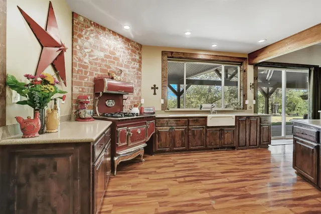 a kitchen with a window a sink and cabinets