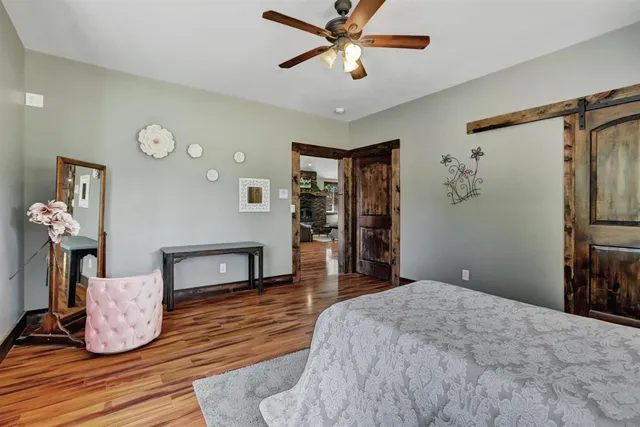 a spacious bedroom with a bed and a chandelier