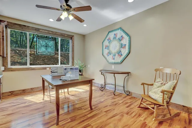 a spacious bedroom with a bed and wooden floor