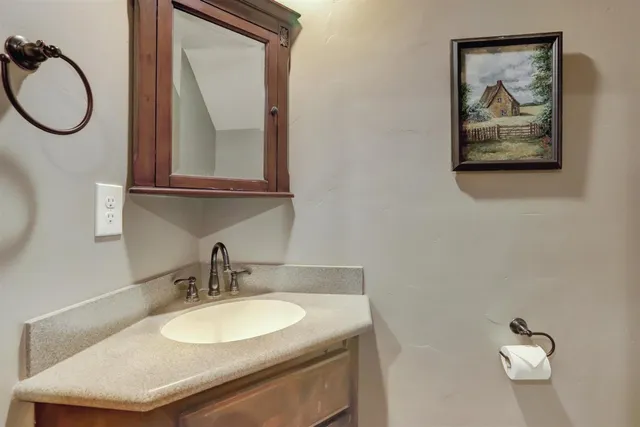 a bathroom with a shower sink vanity and mirror