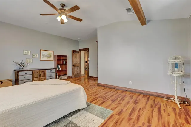 an aerial view of a house with outdoor space and trees all around