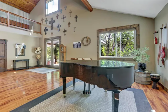 a room with table chairs and wooden floor
