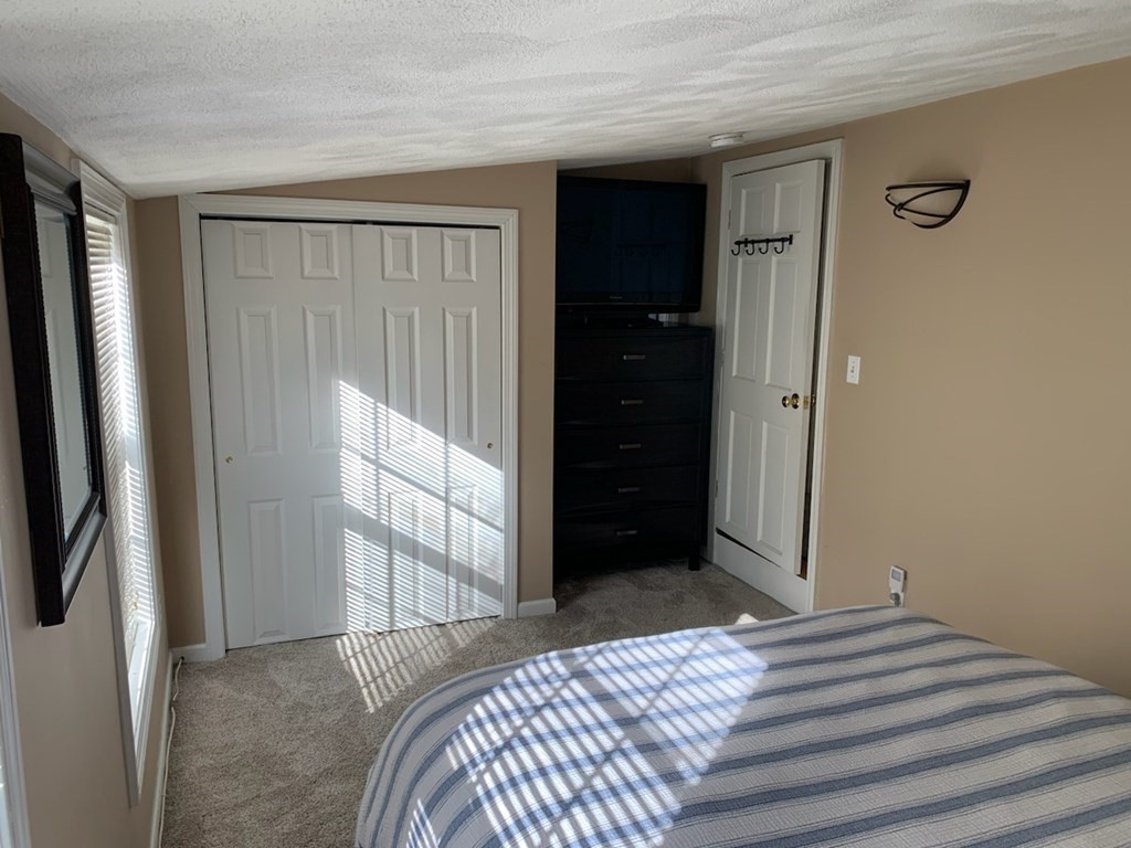 846 Broadway, Unit 45 Saugus, MA 01906 - Photo 11 of 11 a bedroom with a bed and a window