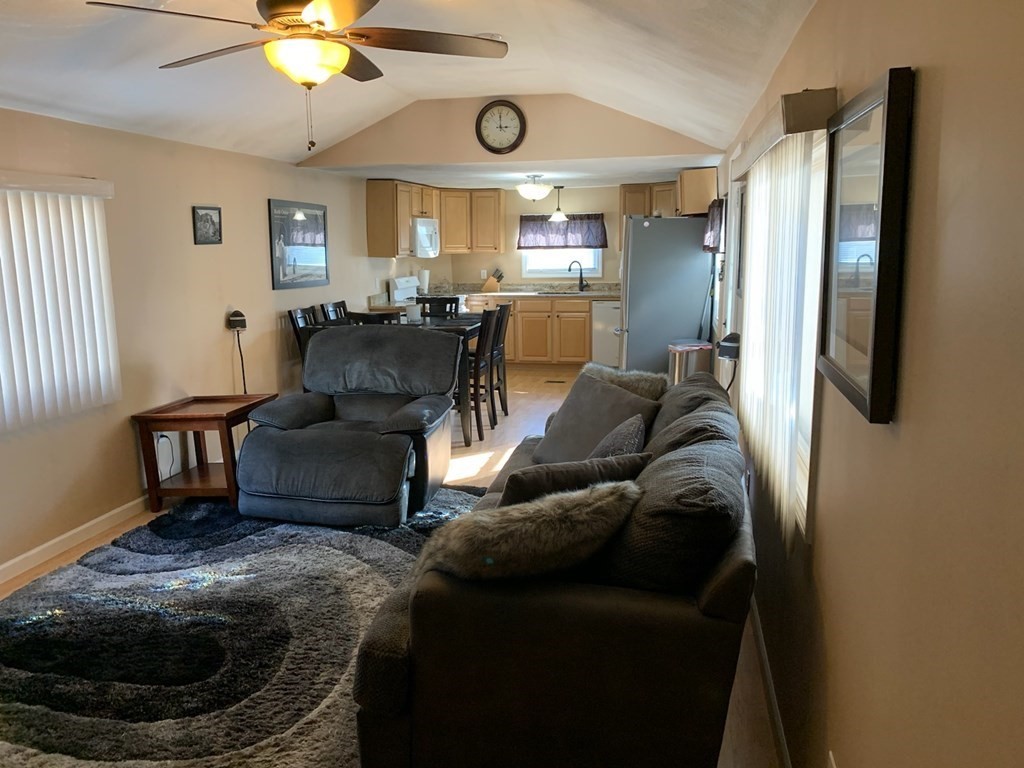 846 Broadway, Unit 45 Saugus, MA 01906 - Photo 3 of 11 a living room with furniture and a chandelier