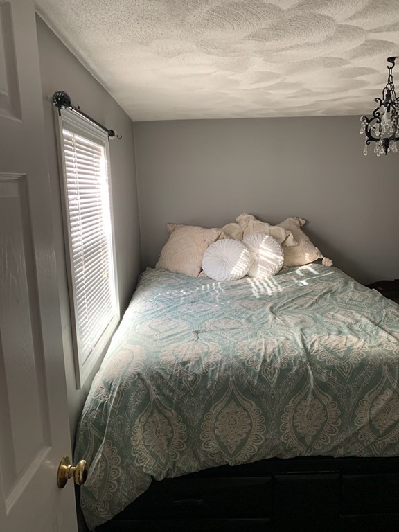 846 Broadway, Unit 45 Saugus, MA 01906 - Photo 7 of 11 a bedroom with a bed and window