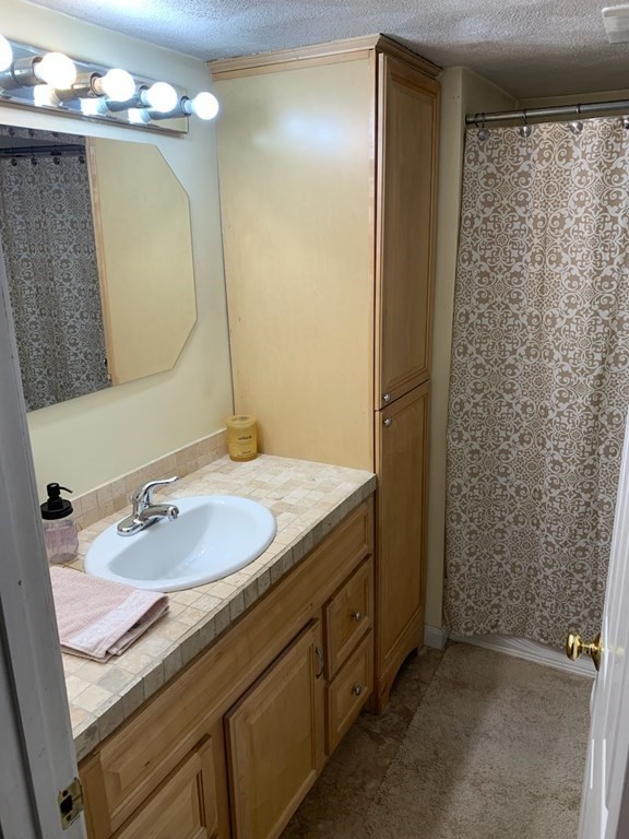 846 Broadway, Unit 45 Saugus, MA 01906 - Photo 10 of 11 a bathroom with a sink and a mirror