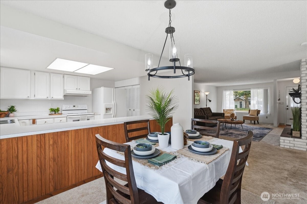 309 West Walnut Street Waterville, WA 98858 - Photo 8 of 28 a view of a dining room and livingroom with furniture wooden floor a chandelier