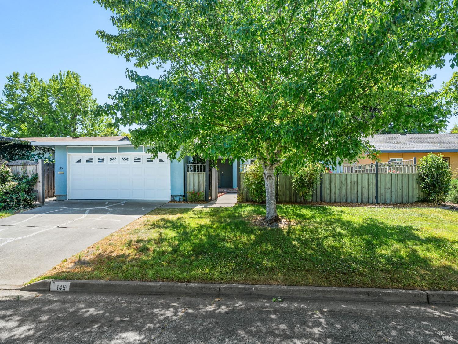 a front view of a house with a yard and a garage