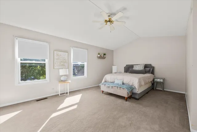 a spacious bedroom with a bed and a window