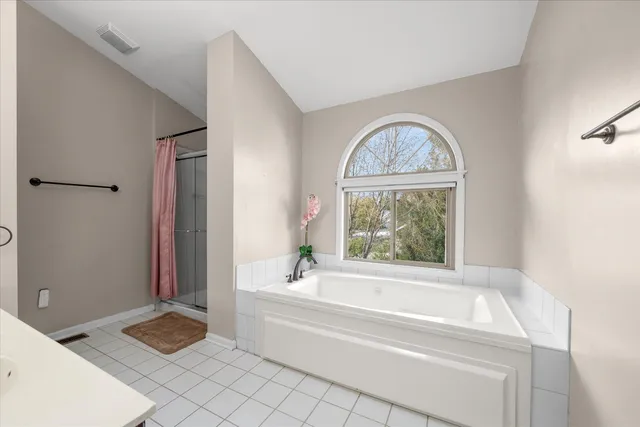 a bathroom with a tub and a window