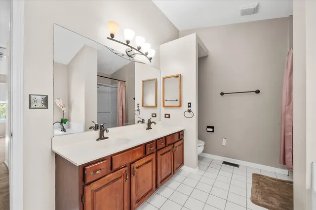 a bathroom with a sink double vanity and a mirror