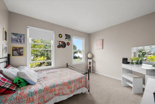 a bedroom with a bed window and table