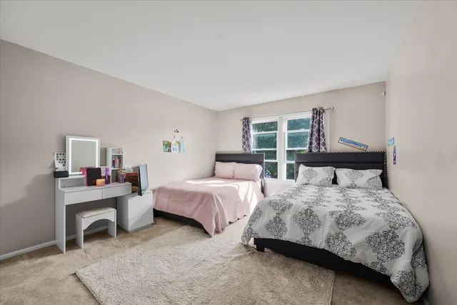 a bedroom with two beds and a window