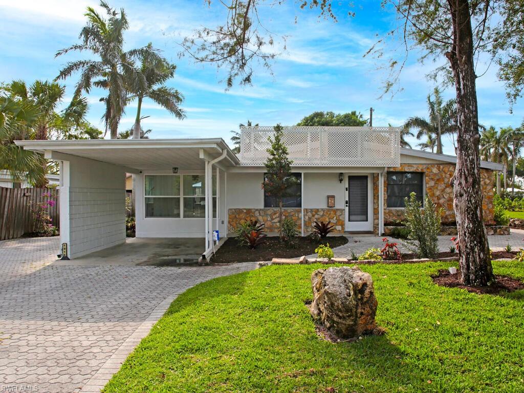 1014 Broad Avenue North Naples, FL 34102 - Photo 1 of 33 a front view of a house with garden and porch