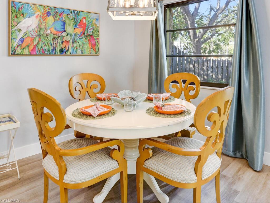 1014 Broad Avenue North Naples, FL 34102 - Photo 13 of 33 a view of a dining room that has a table and a chair with wooden floor