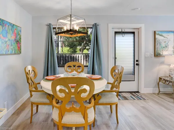 a dining room with furniture and wooden floor