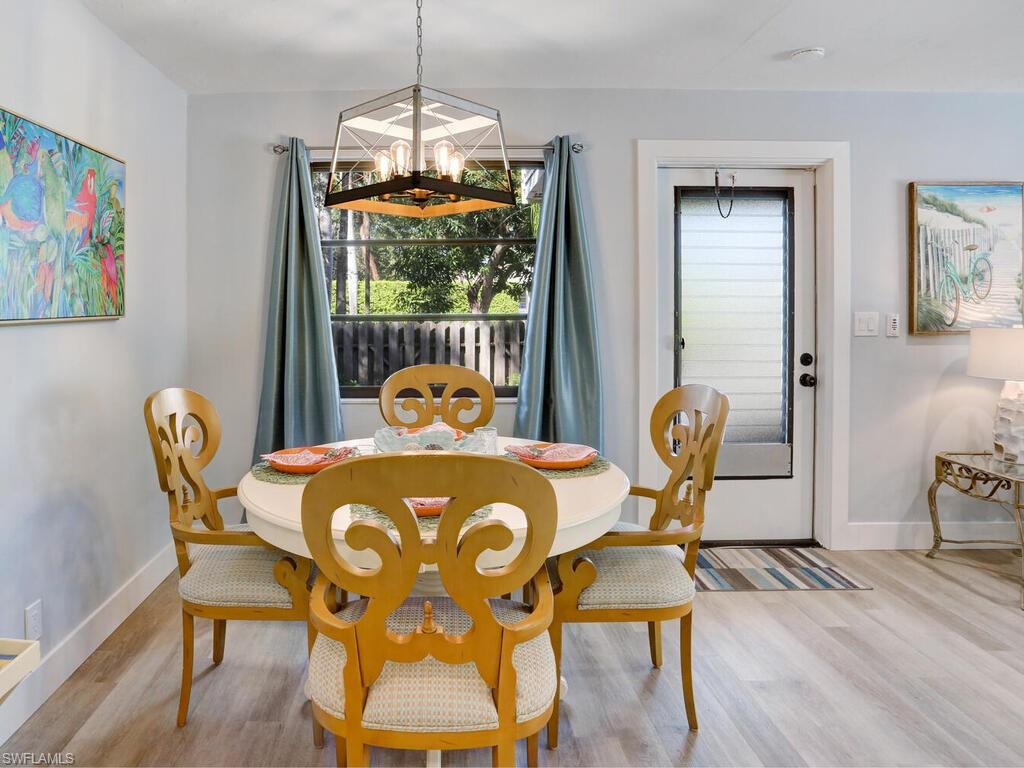 1014 Broad Avenue North Naples, FL 34102 - Photo 14 of 33 a dining room with furniture and wooden floor