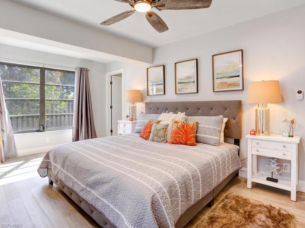 1014 Broad Avenue North Naples, FL 34102 - Photo 17 of 33 a bedroom with a bed and a chandelier