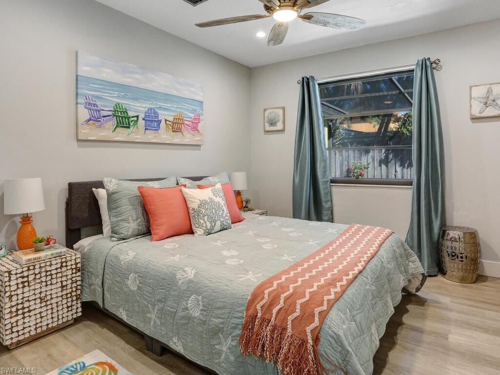 1014 Broad Avenue North Naples, FL 34102 - Photo 20 of 33 a bedroom with a bed and a chandelier