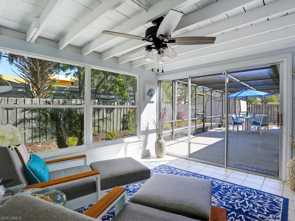 1014 Broad Avenue North Naples, FL 34102 - Photo 26 of 33 a living room with furniture and a floor to ceiling window