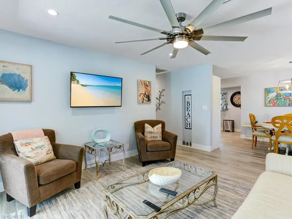 a living room with furniture and a wooden floor