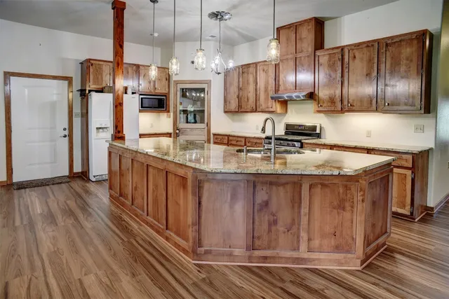 a kitchen with stainless steel appliances granite countertop a stove and a sink