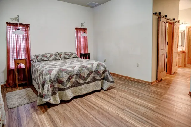 a large kitchen with stainless steel appliances granite countertop a stove a sink dishwasher and a microwave oven with wooden floor