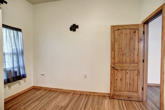 a view of a room with wooden floor and sliding door
