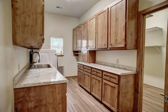 a kitchen with stainless steel appliances granite countertop wooden cabinets a sink and a stove
