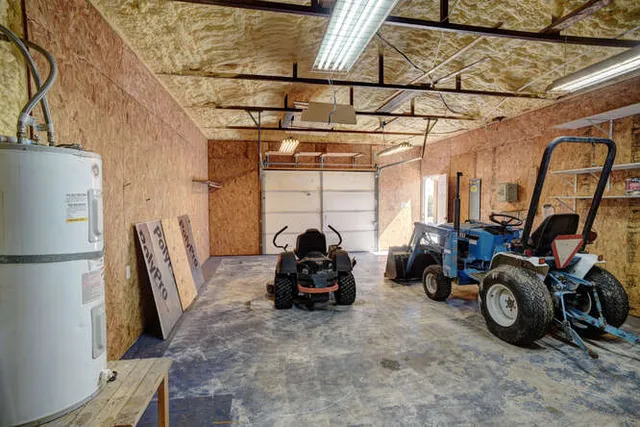 an empty room with closet area and chandelier