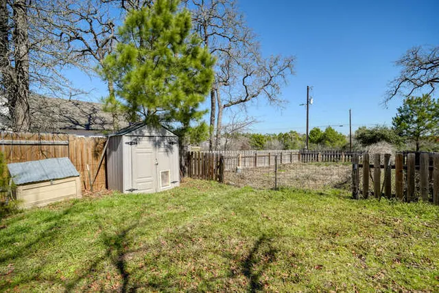 a view of a house with a yard and sitting area