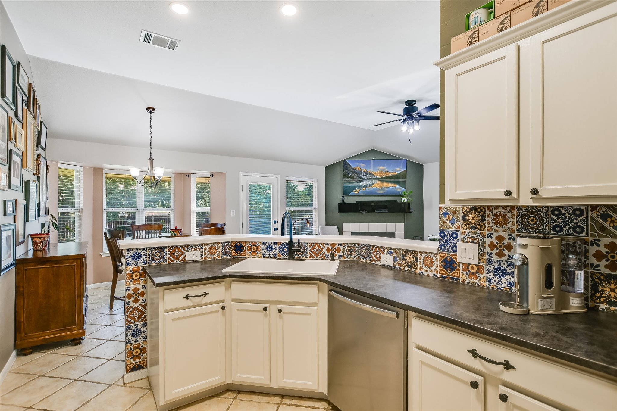 a kitchen with granite countertop a sink and white cabinets