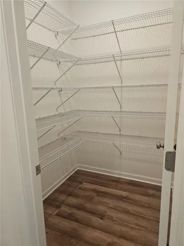 an empty room with a ceiling fan and entryway