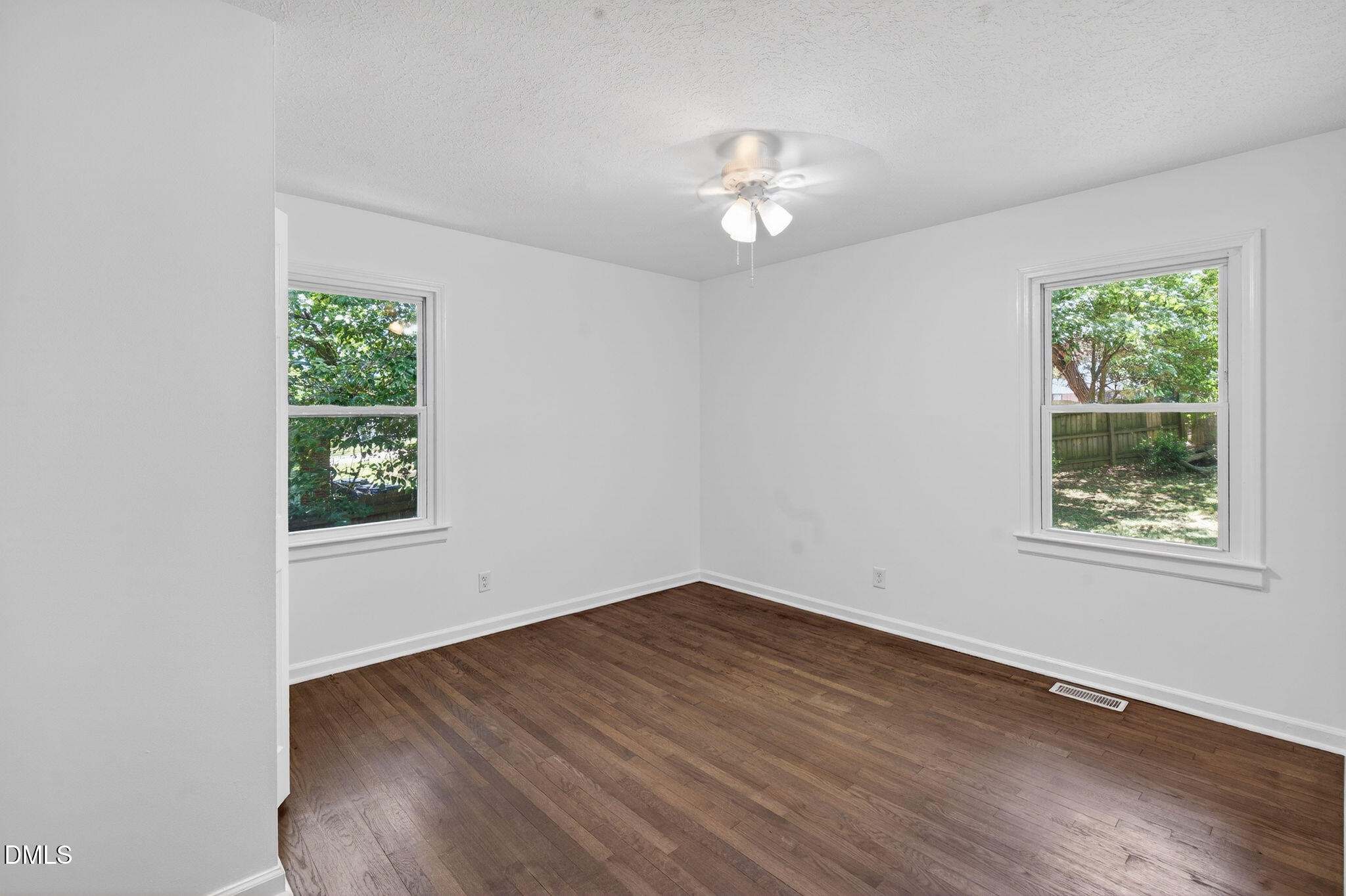 904 Seabrook Road Raleigh, NC 27610 - Photo 10 of 31 a view of an empty room with wooden floor and a window