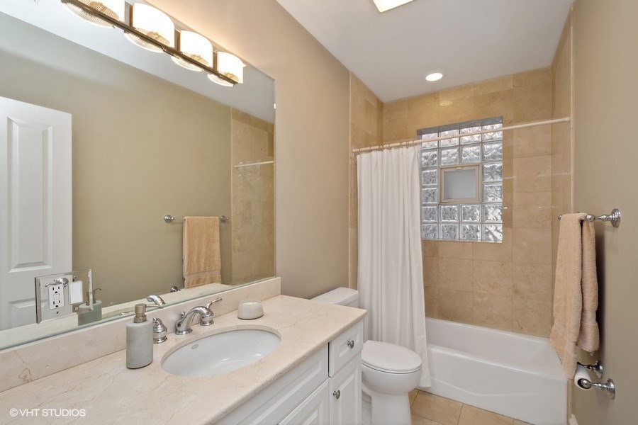 1365 North Mohawk Street, Unit 1S Chicago, IL 60610 - Photo 11 of 15 a bathroom with a granite countertop sink toilet and shower