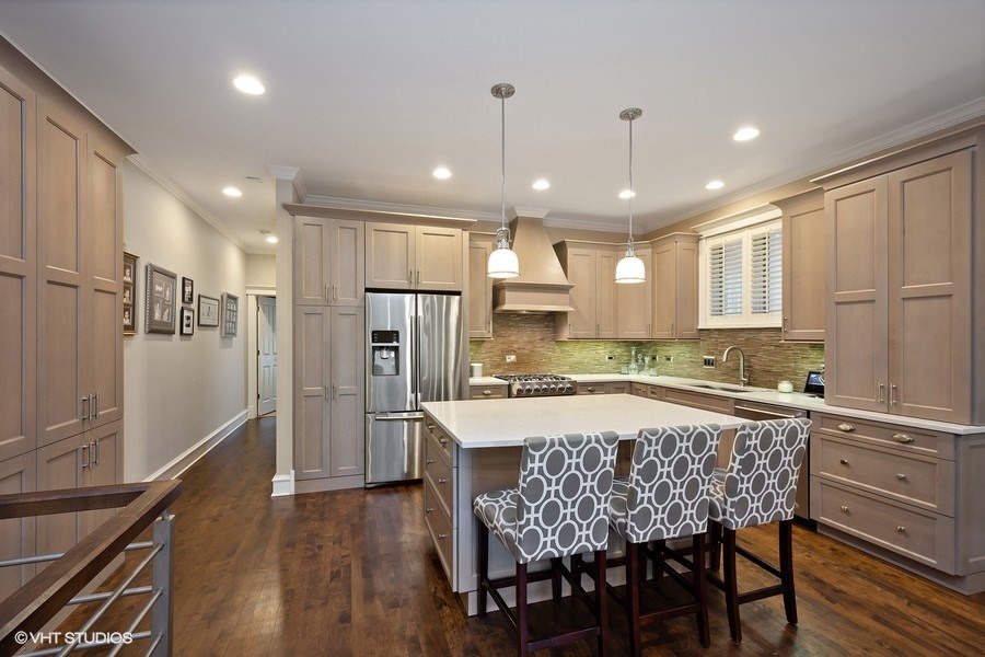 1365 North Mohawk Street, Unit 1S Chicago, IL 60610 - Photo 3 of 15 a kitchen with stainless steel appliances granite countertop a refrigerator a sink dishwasher a dining table and chairs with wooden floor