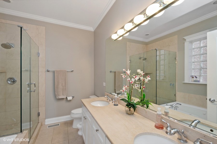 1365 North Mohawk Street, Unit 1S Chicago, IL 60610 - Photo 8 of 15 a bathroom with a granite countertop sink a toilet and shower