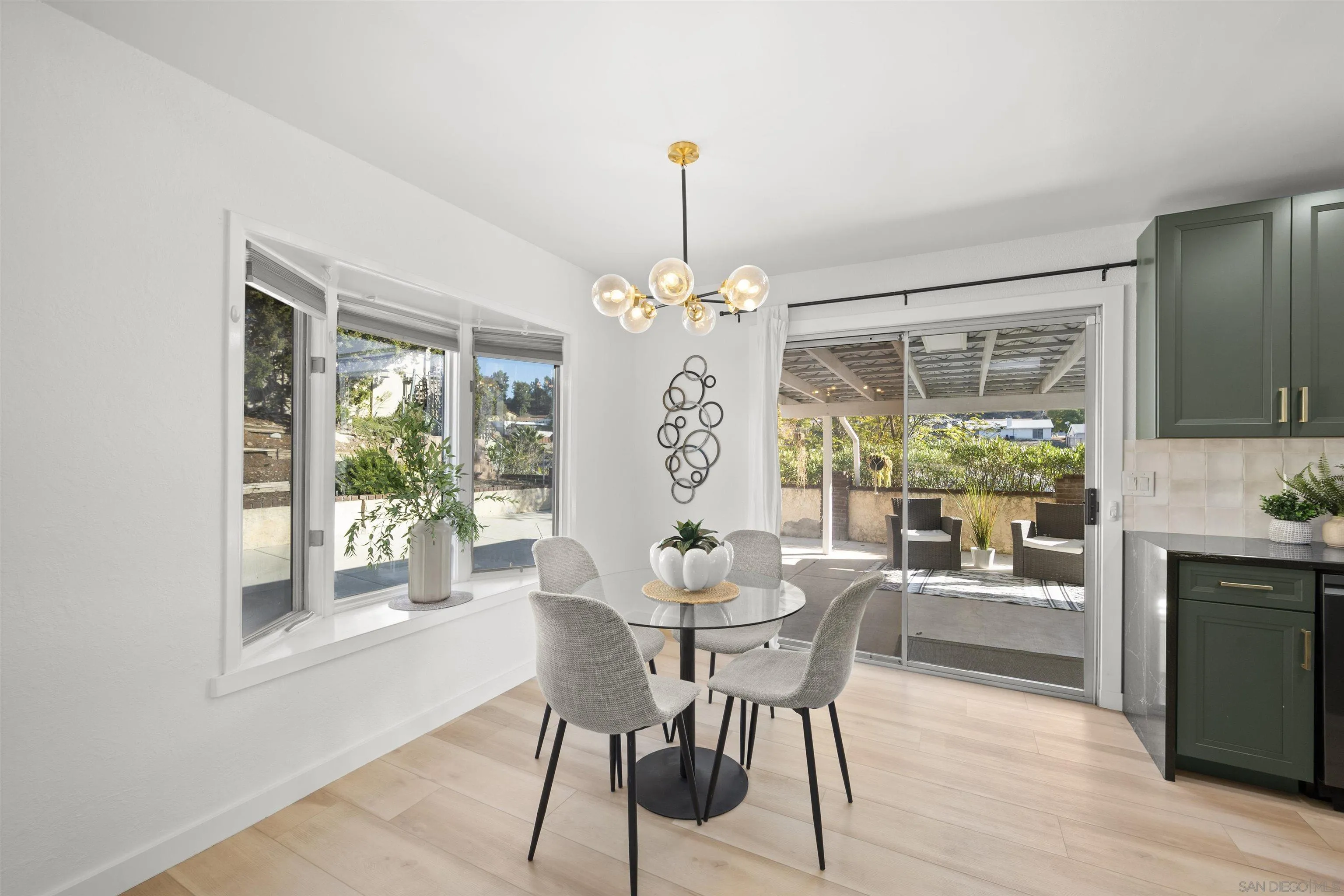 2321 Farrington Drive El Cajon, CA 92020 - Photo 22 of 47 a dining room with wooden floor a chandelier a wooden table and chairs