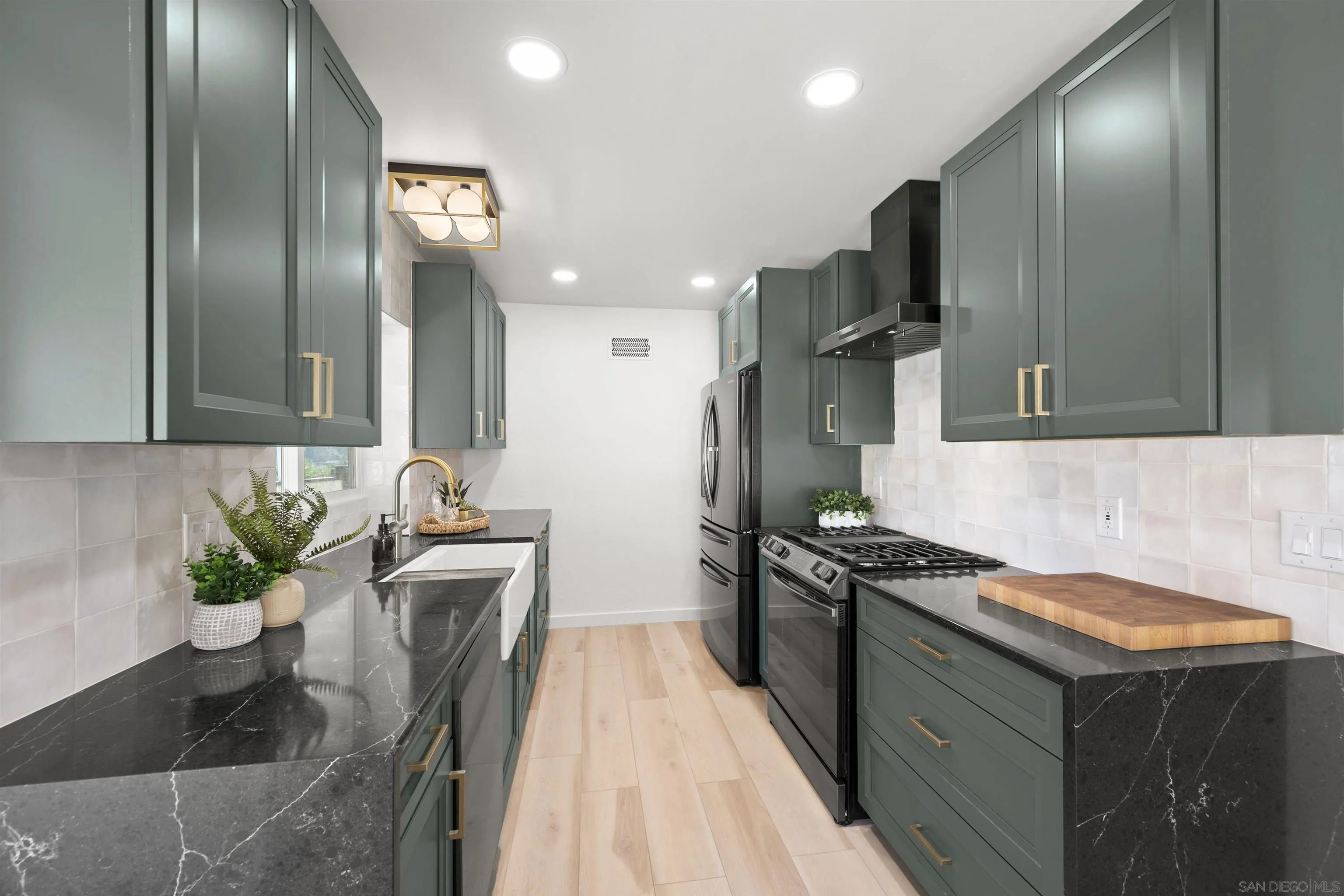 2321 Farrington Drive El Cajon, CA 92020 - Photo 24 of 47 a kitchen with stainless steel appliances granite countertop a sink a stove and a refrigerator
